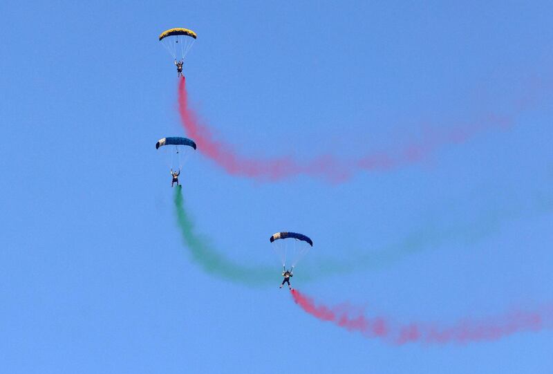 Parachutists leave smoke trails as they perform at Dubai Marina. AFP