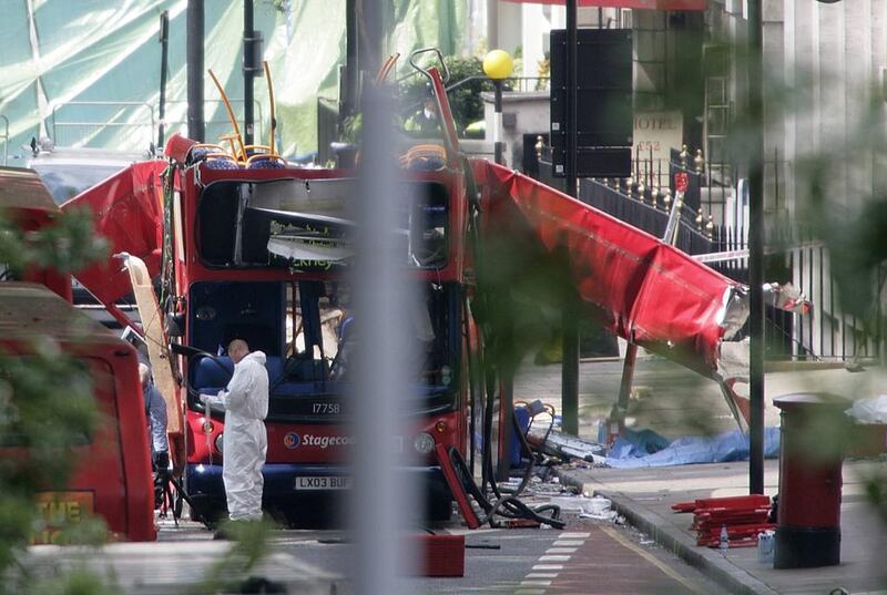 Forensic investigators examine the remains of the bombed out bus in Tavistock square in London. Ten years on from the 7/7 attacks, the extremist threat is very different. (AFP Photo/Odd Andersen)