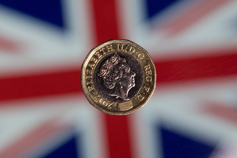 (FILES) In this file photo taken on December 14, 2017 a British one pound sterling coin is arranged for a photograph in front of a Union flag in London.  The British pound slid below $1.20 on September 3, 2019, for the first time since the start of 2017, as the UK faces a possible general election amid Brexit turmoil. Sterling hit $1.1972 around 0640 GMT, as British Prime Minister Boris Johnson faces a rebellion by his own lawmakers over his Brexit strategy that could result in an early general election next month. / AFP / Justin TALLIS
