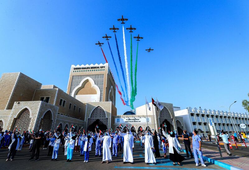 Abu Dhabi, United Arab Emirates, June 21, 2020.   
  The UAE Air Force's aerobatic display team, Al Fursan,  flies over Sheikh Khalifa Medical City, in an initiative of appreciation by the General Command of the UAE Armed Forces for the nation's medical teams and staff.
Victor Besa  / The National
Section:  NA
Reporter: