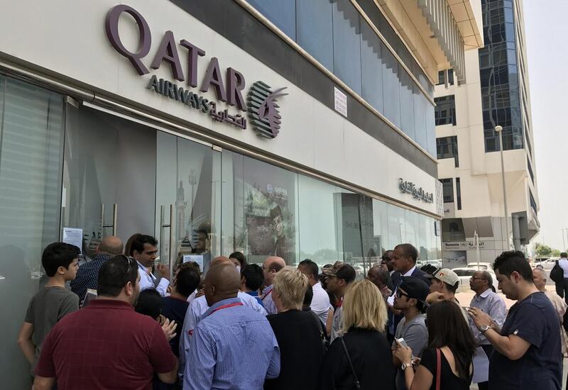 Qatar Airways customers at a branch in Abu Dhabi. Ali Khalil / AFP Photo