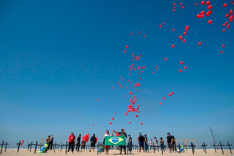 A thousand red balloons are released during a tribute to Covid-19 victims organised by the Rio de Paz NGO at the Copacabana beach in Rio de Janeiro, Brazil. AFP