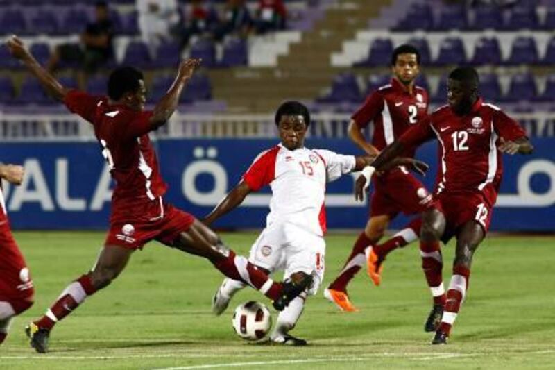 Al Ain, United Arab Emirates, Aug 25 2011, UAE national team  vs Qatar-  (center white kit) UAE's #15 Ismail Al Hammadi works out of trouble near the goal.  UAE defeated Qatar 3-1 at the whistle. Mike Young / The National?