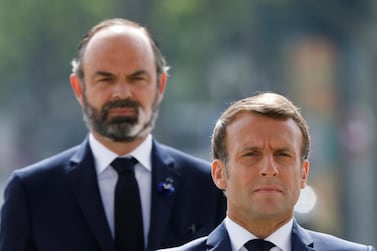 FILE - In this May 8, 2020 file photo, French President Emmanuel Macron, right, and French Prime Minister Edouard Philippe attend a ceremony to mark the 75th anniversary of the World War II victory over Nazi Germany, at the Arc de Triomphe in Paris. A new French prime minister will be appointed on Friday to replace Edouard Philippe, who has resigned amid an expected government reshuffle, the French presidency announced. (Charles Platiau/Pool via AP, File)