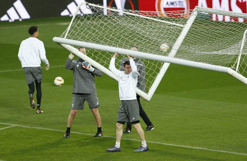 Liverpool’s James Milner helps move the goal posts during training. Action Images via Reuters / Lee Smith
