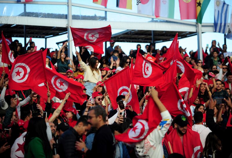 Tunisia soccer fans gather to watch their national team play against Denmark in a World Cup soccer match played in Qatar, on a large screen set up for fans in Tunis, Tunisia, Tuesday, Nov.  22, 2022.  (AP Photo / Hassene Dridi)