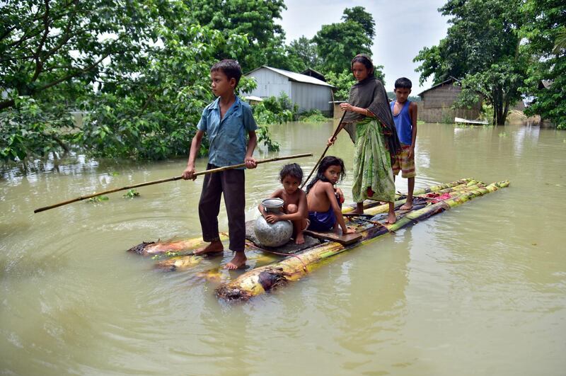 Villagers row a makeshift raft through a flooded field to reach a safer place at the flood-affected Mayong village in Morigaon district, in the north-east Indian state of Assam. Reuters