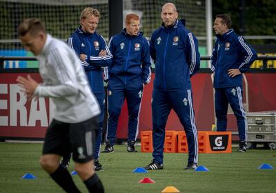 Dutch Feyenoord's coaches and former players Dirk Kuyt (L) and Jaap Stam (R) attend a training of their team on the eve the Europa League match against FC Porto. Netherlands OUT
 / AFP / ANP / Jerry Lampen
