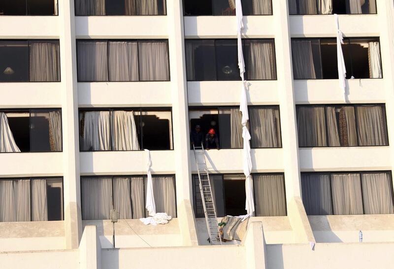 Rescue workers conduct a search operation after a fire in the Regent Plaza hotel in Karachi, Pakistan. The fire was believed to have started in the hotel’s kitchen. Rehan Khan / EPA