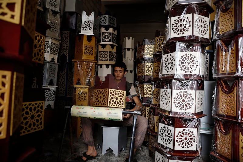 A Yemeni prepares decorated Arabic tables for sale ahead of  Eid Al Fitr.  EPA 