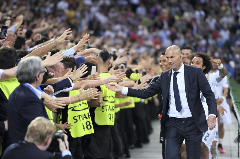 MILAN, ITALY - MAY 28:  Zinedine Zidane manager of Real Madrid high fives with supporters after the UEFA Champions League Final between Real Madrid and Club Atletico de Madrid at Stadio Giuseppe Meazza on May 28, 2016 in Milan, Italy..  (Photo by Stuart Franklin - UEFA/UEFA via Getty Images)
