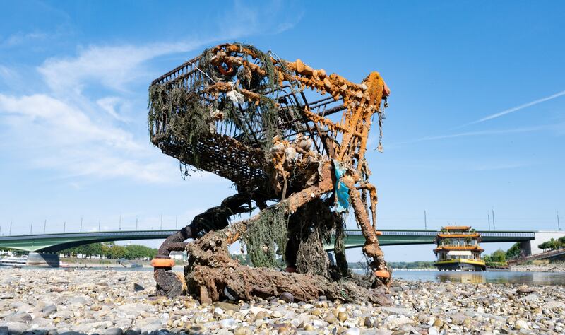 A rusted shopping cart in the Rhine river exposed by the low tide in Bonn, Germany. Reuters