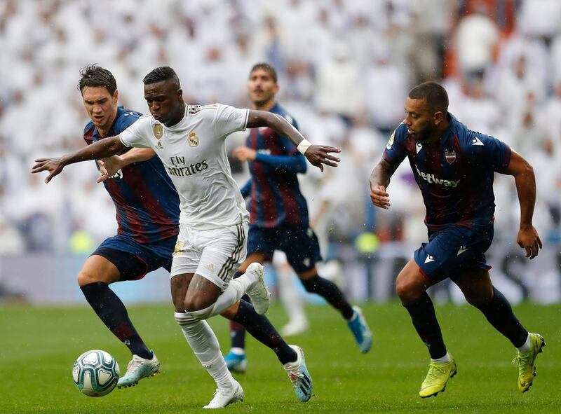 Real Madrid's Vinicius Junior, second left, vies for the ball with Levante defenders. AP Photo