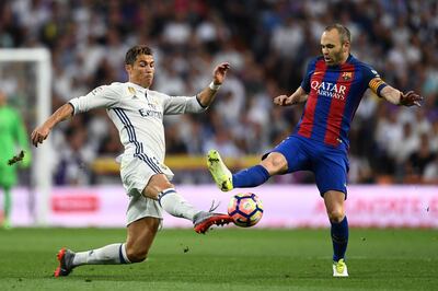 MADRID, SPAIN - APRIL 23:  Cristiano Ronaldo of Real Madrid and Andres Iniesta of Barcelona battle for the ball during the La Liga match between Real Madrid CF and FC Barcelona at Estadio Bernabeu on April 23, 2017 in Madrid, Spain.  (Photo by David Ramos/Getty Images)