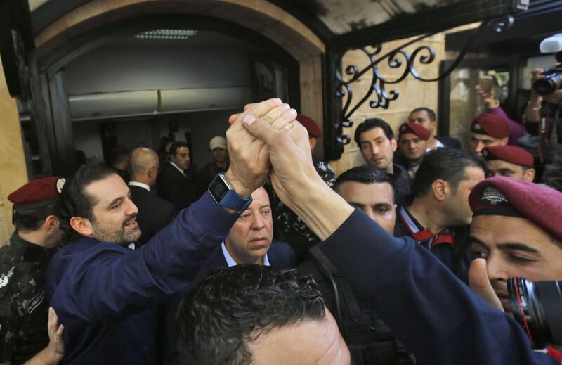 Lebanese prime minister Saad Hariri (L) greets his supporters upon his arrival at his home in Beirut on November 22, 2017.
Hariri, back in Beirut after a mysterious odyssey that saw him announce his resignation in Saudi Arabia, told cheering supporters that he was staying. / AFP PHOTO / STR