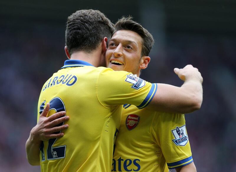 Mesut Ozil, right, congratulates Olivier Giroud after the German set up the Frenchman to open the scoring against Sunderland. Scott Heppell / AP Photo