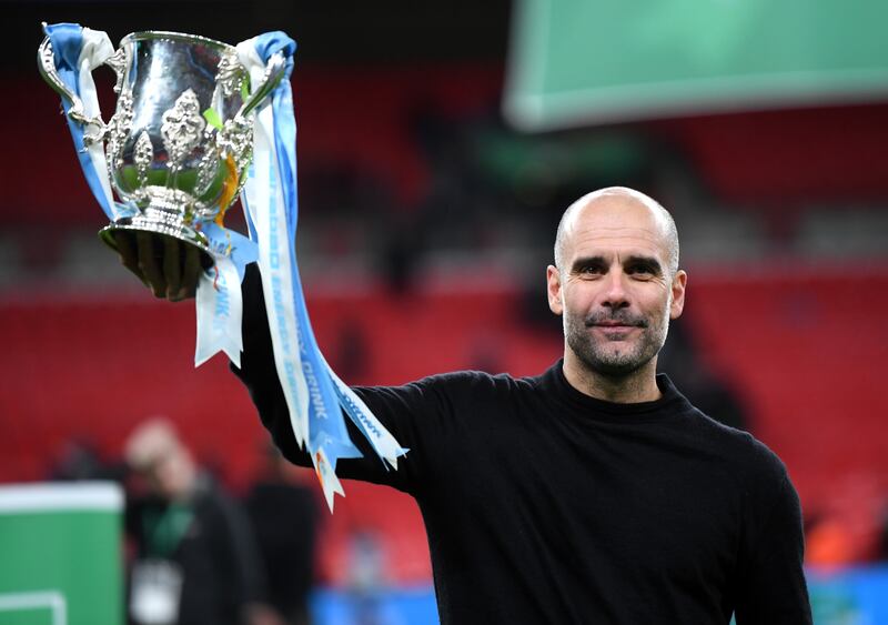 Pep Guardiola celebrates after winning the League Cup in 2020. Getty