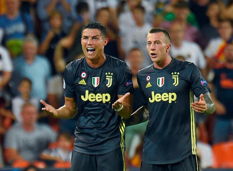 Cristiano Ronaldo and Federico Bernardeschi argue against the decision. AFP