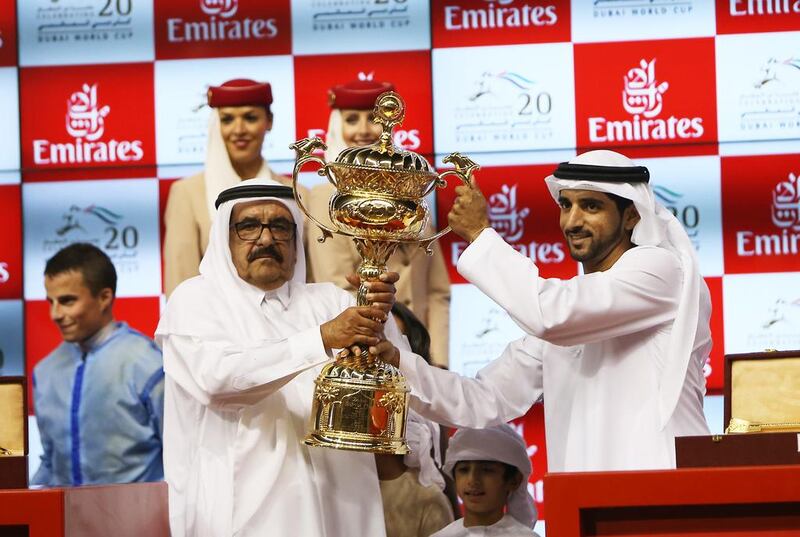 Sheikh Hamdan bin Rashid is presented with the 2015 Dubai World Cup trophy after Prince Bishop won the showpiece race. Pawan Singh / The National