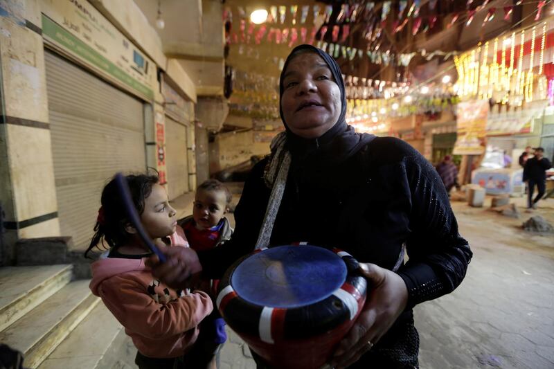 Hajja Dalal beats a drum to wake up Muslims to have the predawn meal before they start their long-day fast, during the holy month of Ramadan, at Maadi neighbourhood in Cairo, Egypt. Reuters