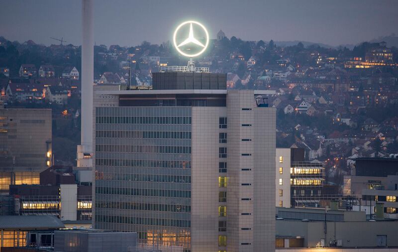 The Mercedes star is illuminated on the headquarters of Daimler AG in Stuttgart, southwestern Germany, on February 1, 2017, the day before German luxury carmaker Daimler AG's annual results press conference. (Photo by THOMAS KIENZLE / AFP)