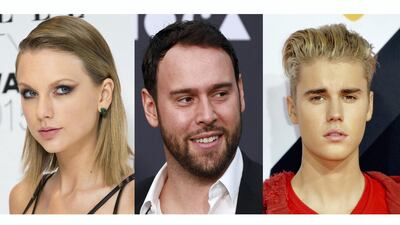 Scooter Braun, centre, is the reason for the feud between the two pop stars. Getty