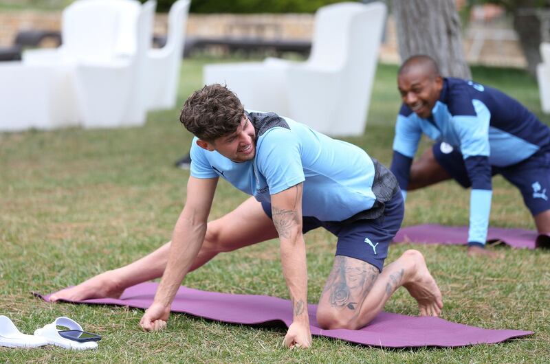 LISBON, PORTUGAL - AUGUST 11: John Stones of Manchester City takes part in a stretching session in the build up to the UEFA Champions League Quarter Final match at the team hotel on August 11, 2020 in Lisbon, Portugal. (Photo by Victoria Haydn/Manchester City FC via Getty Images)