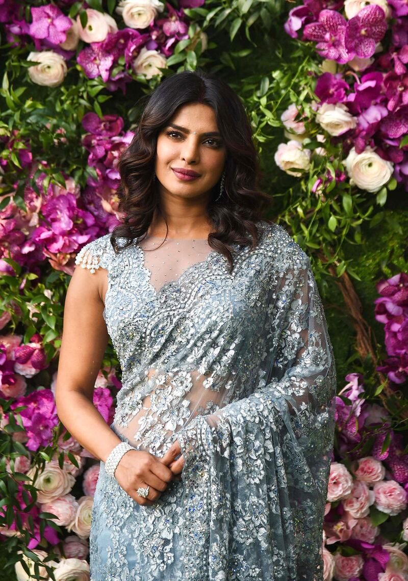 Bollywood actress Priyanka Chopra poses for photographs as she arrives to attend the wedding ceremony of Akash Ambani, son of Indian businessman Mukesh Ambani, in Mumbai on March 9, 2019. / AFP / SUJIT JAISWAL
