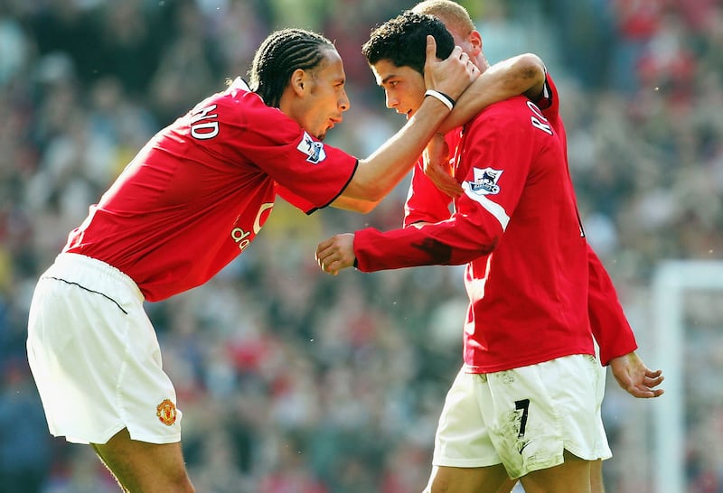 Rio Ferdinand congratulates goal scorer Cristiano Ronaldo during a Premier League match in 2005. Getty Images