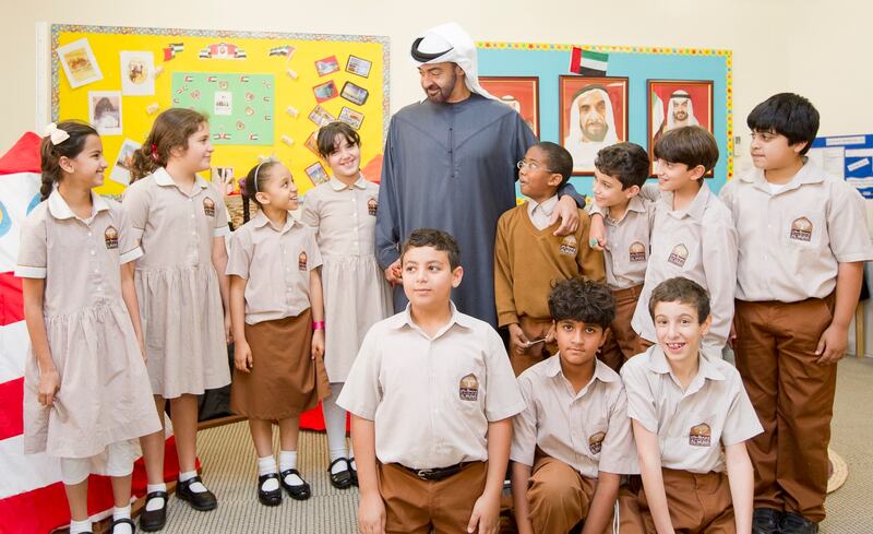Mohamed bin Zayed poses for a photo with schoolchildren. Photo: @MohamedBinZayed