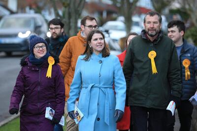 Britain's opposition Liberal Democrats leader Jo Swinson (C) walks with Liberal Democrat candidates for Sheffield Central Colin Ross (R) and Penitsone and Stocksbridge Hannah Kitching (L) and volunteers while out canvassing for the general election in Sheffield, northern England on December 8, 2019.  Britain will go to the polls on December 12, 2019 to vote in a pre-Christmas general election. / AFP / Lindsey Parnaby
