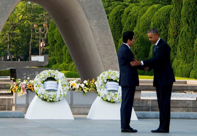 US president Barack Obama, right, and Japanese prime minister Shinzo Abe shake hands after laying wreaths at the Hiroshima Peace Memorial Park. Jim Watson / AFP