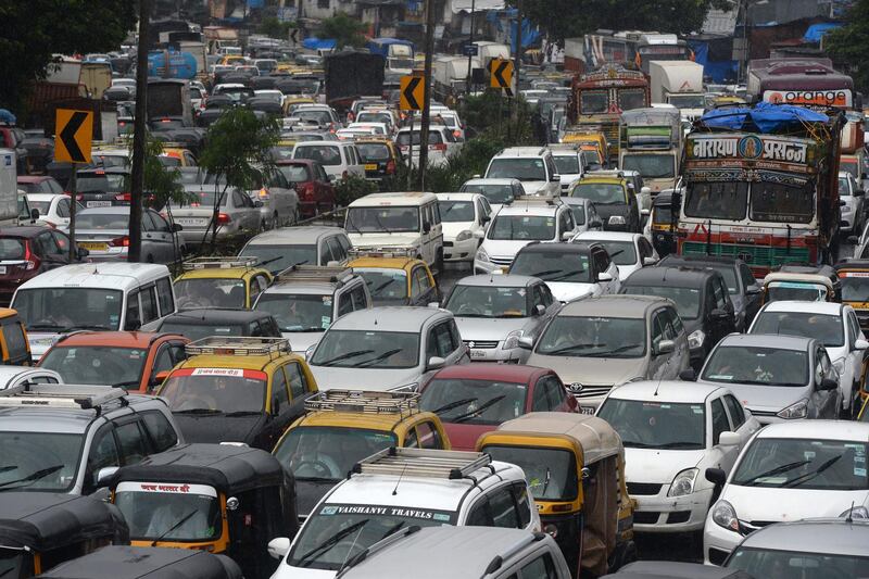 Heavy traffic is seen on a highway during heavy rain showers in Mumbai on September 4, 2019. (Photo by PUNIT PARANJPE / AFP)