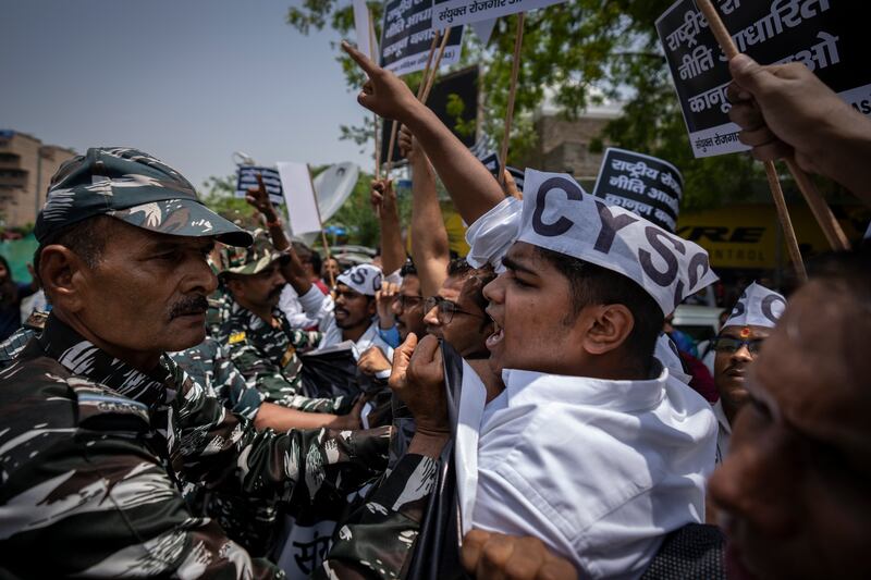 Indian paramilitary personnel try to stop students and activists in New Delhi. AP