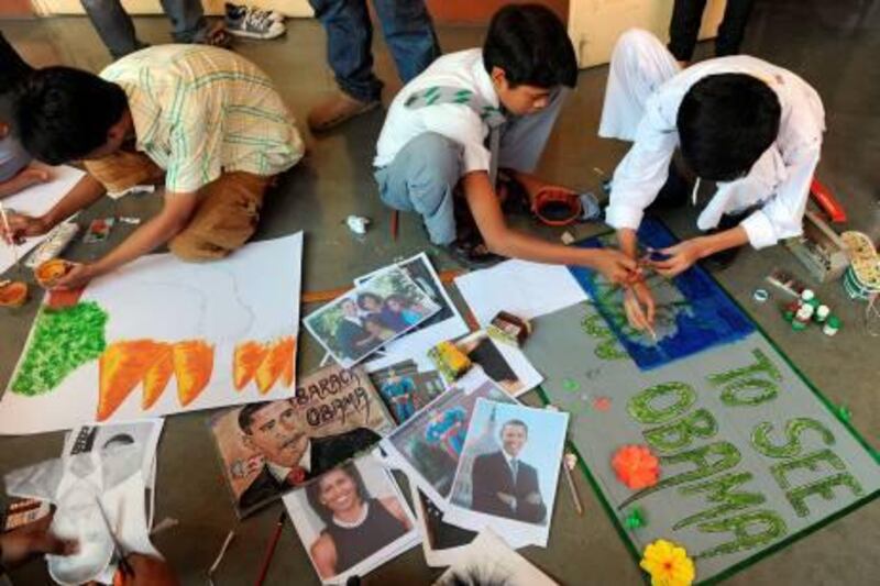 Indian children make sketches and paintings of US President Barack Obama in Mumbai on November 2, 2010. The US president arrives next week for a three-day visit and faces the unusual challenge of living up to the enormous popularity of his predecessor, George W. Bush, who was widely feted here for ending India's status as a nuclear pariah. AFP PHOTO/ Punit PARANJPE
 *** Local Caption ***  555632-01-08.jpg