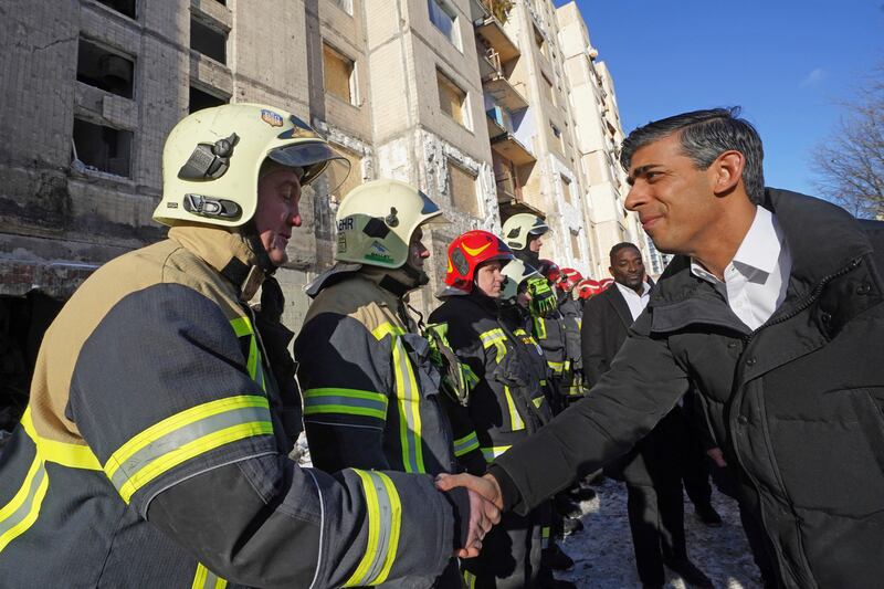 Mr Sunak meeting firefighters in Kyiv. AP