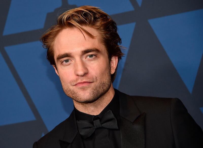(FILES) In this file photo taken on October 27, 2019 British actor Robert Pattinson arrives to attend the 11th Annual Governors Awards gala hosted by the Academy of Motion Picture Arts and Sciences at the Dolby Theater in Hollywood.  Robert Pattinson showcased "The Batman" footage and Dwayne "The Rock" Johnson hyped up his new anti-hero movie "Black Adam" as Hollywood A-listers and their comic-book alter-egos hosted a sprawling DC Comics online gathering August 22, 2020. / AFP / Chris Delmas
