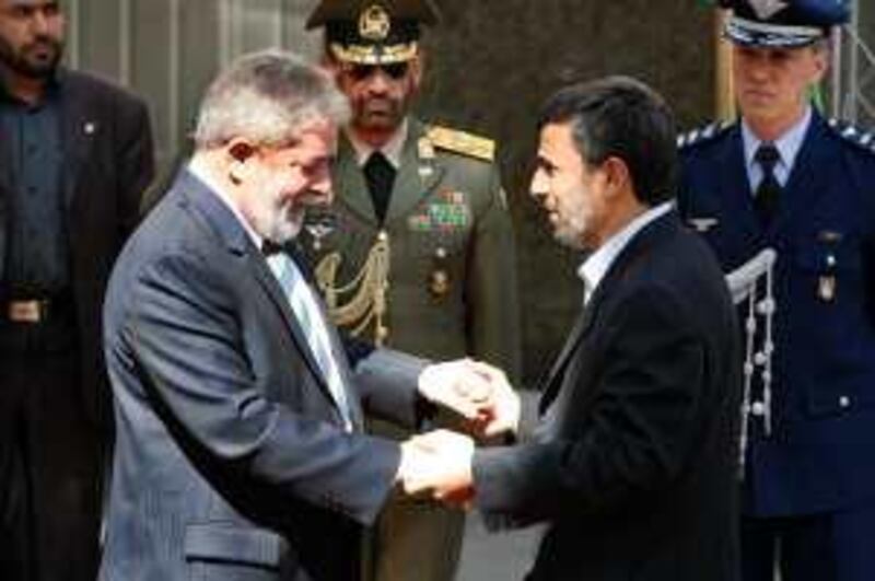 Iranian President Mahmoud Ahmadinejad, right, welcomes his Brazilian counterpart Luis Inacio Lula da Silva during an official welcoming ceremony at the presidency in Tehran, Iran, Sunday, May 16, 2010. (AP Photo/Vahid Salemi) *** Local Caption ***  VAH103_Mideast_Iran_Brazil.jpg