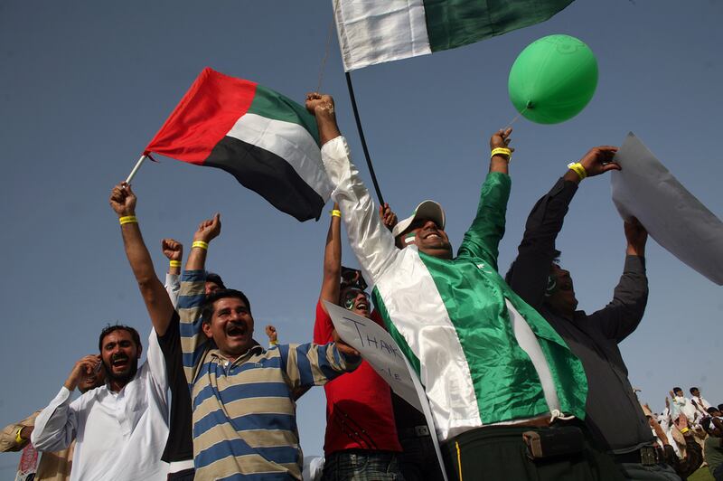 Cricket fans wave UAE and Pakistan flags during a match between Pakistan and Australia at the Zayed Cricket Stadium in Abu Dhabi in 2009.