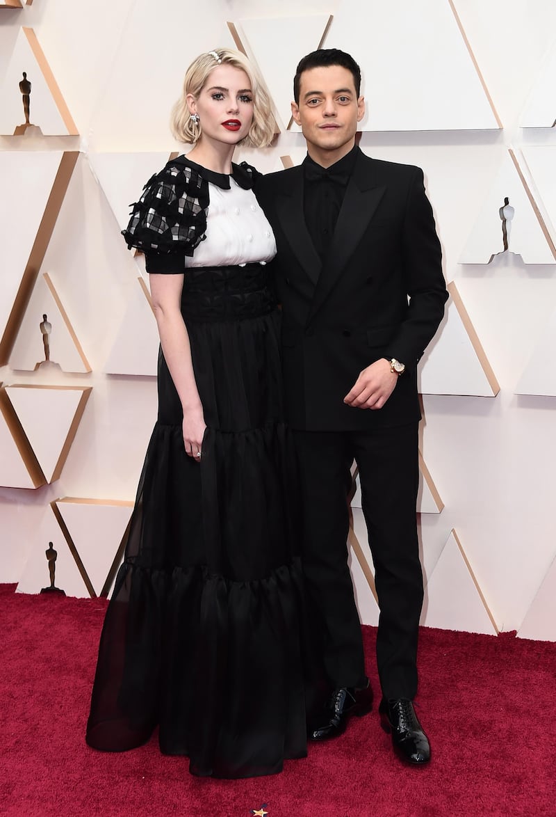 Lucy Boynton and Rami Malek, wearing Saint Laurent, arrive at the Oscars on Sunday, February 9, 2020, at the Dolby Theatre in Los Angeles. AP