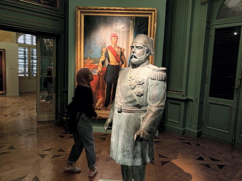 A visitor looking at a bronze statue of Khedive Ismail (1830-1895) who ruled Egypt during the 19th century, at an exhibition of paintings and sculptures of the royal family, toppled in 1952. Hamza Hendawi / The National 