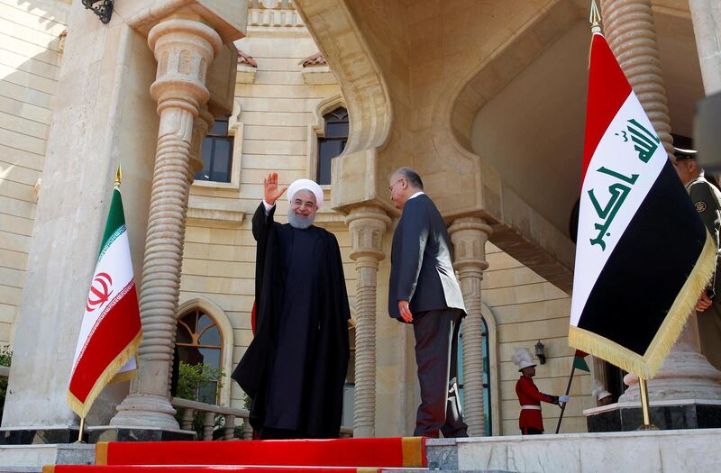 Iranian President Hassan Rouhani waves his hand during a welcome ceremony at Salam Palace in Baghdad, Iraq. Reuters