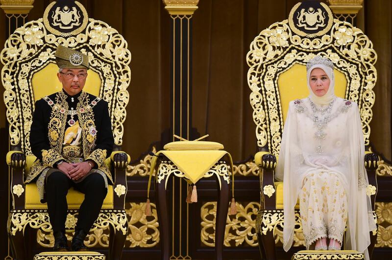 Malaysia's King Sultan Abdullah and Queen Tunku sit on the throne at the National Palace in Kuala Lumpur. Malaysia Information Ministry via AP