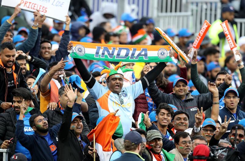 India fans in good spirits as play resumes during the match after a rain break. PA Wire