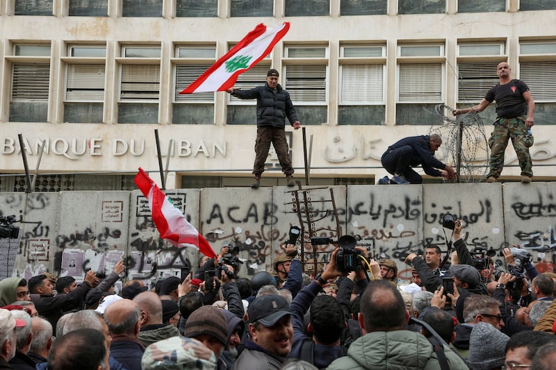 Lebanese protest against the deteriorating economic situation in front of the central bank's building in Beirut. Reuters
