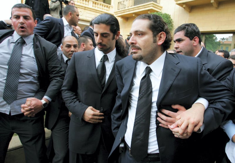 The son of Lebanon's slain former prime minister Rafiq Hariri, Saadeddine (R), and other family members leave their family home to join the funeral procession in Beirut 16 February 2005. Hariri's funeral cortege left his home to his final resting place in central Beirut accompanied by thousands of mourners amid a heavy security presence. Hariri, 60, was killed in a massive explosion in Beirut 14 February.  AFP PHOTO/RAMZI HAIDAR (Photo by RAMZI HAIDAR / AFP)