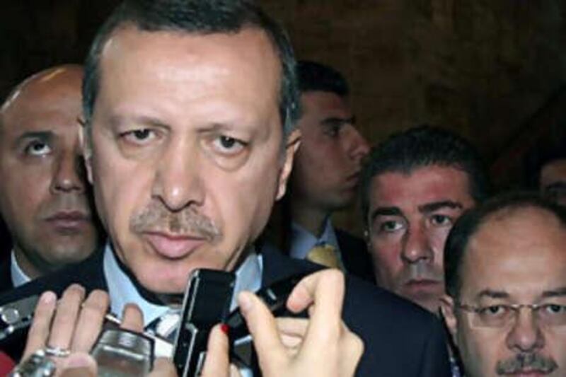 Turkey's Prime Minister Tayyip Erdogan speaks to the media yesterday, after Turkish police detained 21 people during raids against an alleged network of  nationalists accused of plotting to topple the government,