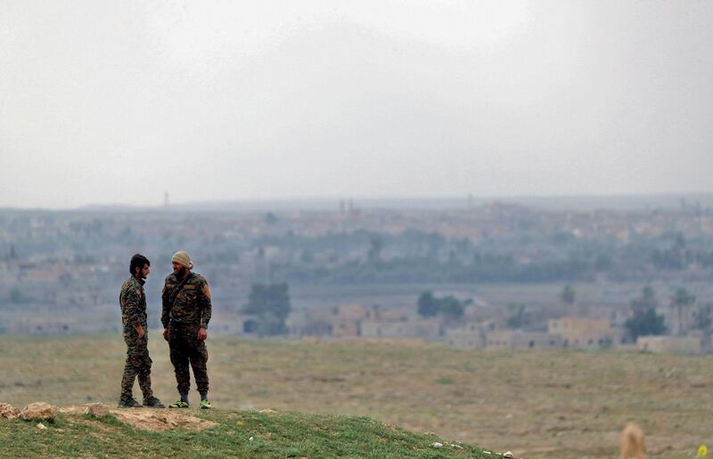 Fighters with the US-backed Syrian Democratic Forces (SDF) stand at a position in the Baghouz area in the eastern Syrian province of Deir Ezzor on February 14, 2019 during an operation to expel hundreds of Islamic State group (IS) jihadists from the region.
 Syrian fighters backed by artillery fire from a US-led coalition battled a fierce jihadist counteroffensive as they pushed to retake a last morsel of territory from the Islamic State group in an assault lasting days. More than four years after the extremists declared a "caliphate" across large parts of Syria and neighbouring Iraq, several offensives have whittled that down to a tiny scrap of land in eastern Syria. / AFP / Delil souleiman
