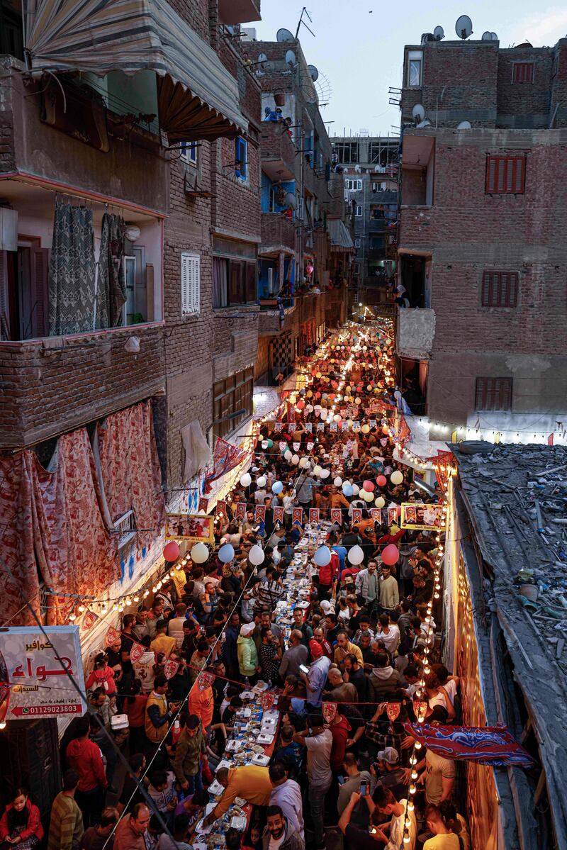 People line the street during the mass iftar event 