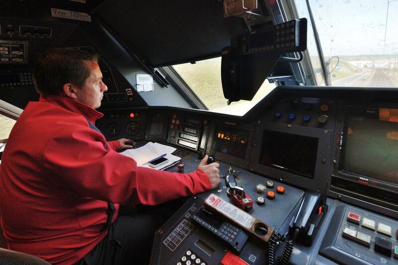 Above, train driver Willy Crooks, who drove Queen Elizabeth II and French president Francois Mitterrand between Calais and Folkestone during the tunnel's inauguration on May 6, 1994. A record 20.4 million passengers were transported between Britain and France using the tunnel in 2013. Denis Charlet / AFP